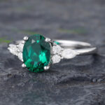 Pattiring Oval Cut Emerald White Gold Cluster Engagement Ring