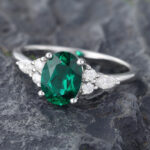 Pattiring Oval Cut Emerald White Gold Cluster Engagement Ring