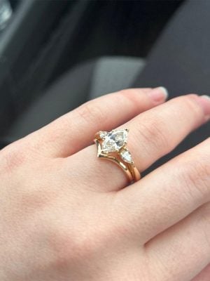 Bride's finger with wedding bands